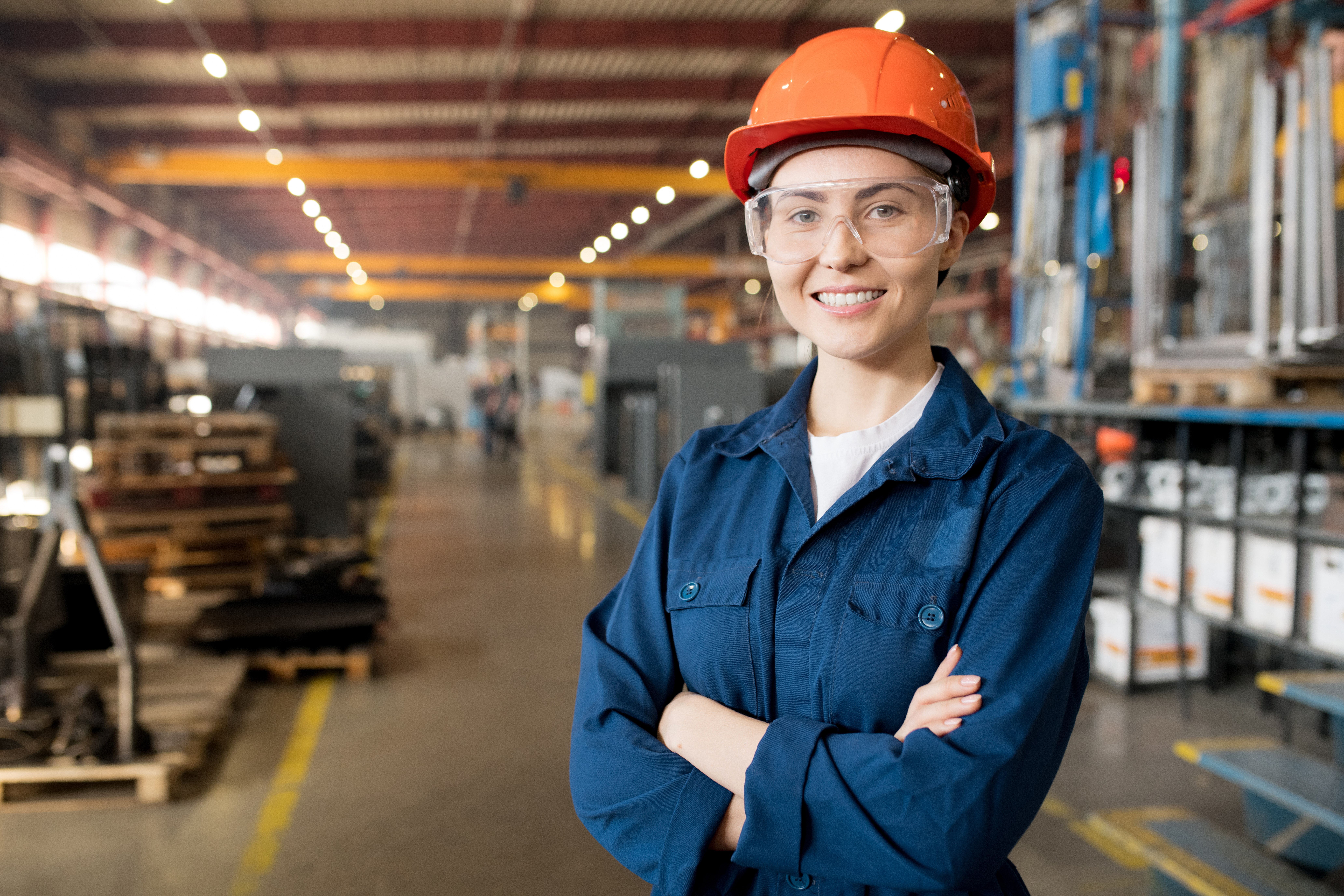 Young female worker in warehouse smiling